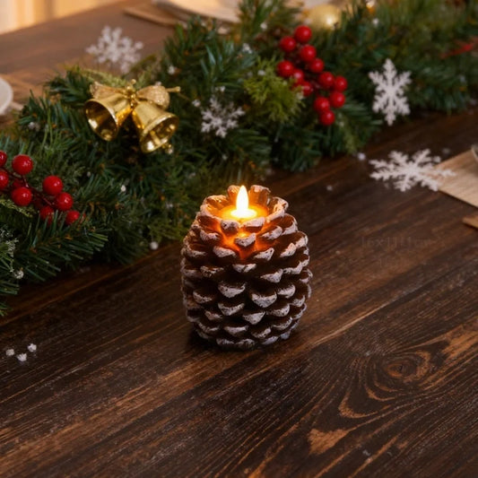 Pinecone flameless candle in dining table setting — white-tipped brown scales, lit LED flame | Casa Norex