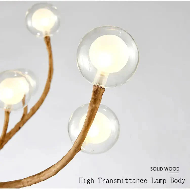 Tree chandelier lit over dining table — Casa Norex