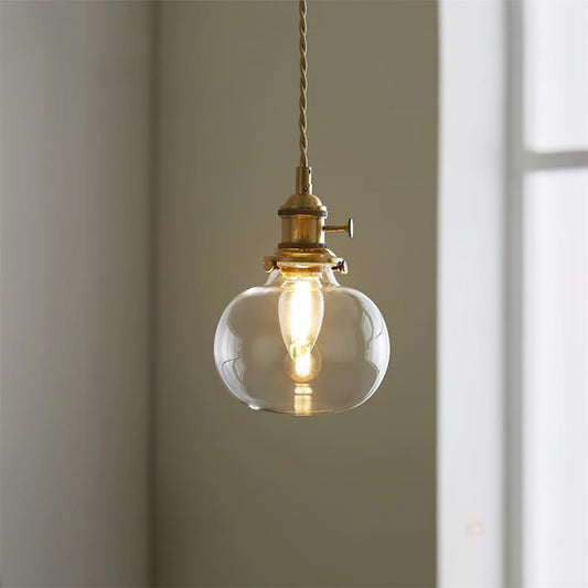 Pendant light in dining room setting — warm brass glow | Casa Norex