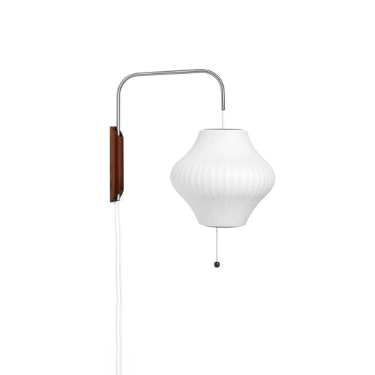 Nelson wall sconce capsule shape in bedroom setting - Casa Norex