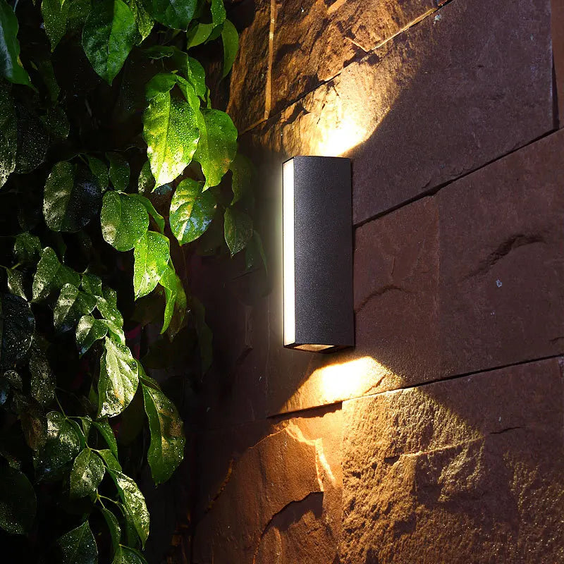 Porto aluminum wall light warm white glow at night — Casa Norex
