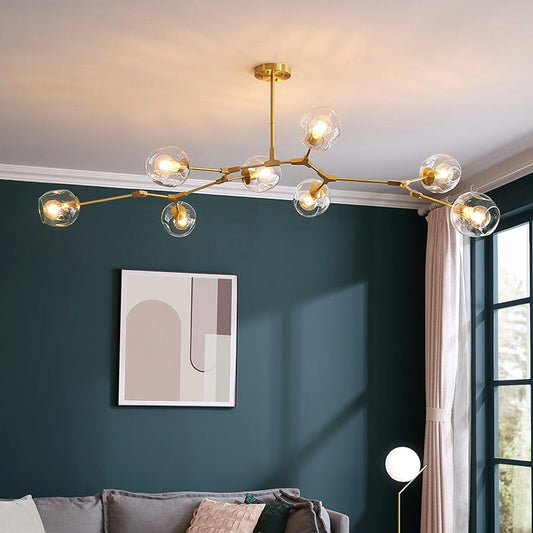 Clear globe arm chandelier in dining room setting — 6-light warm glow | Casa Norex