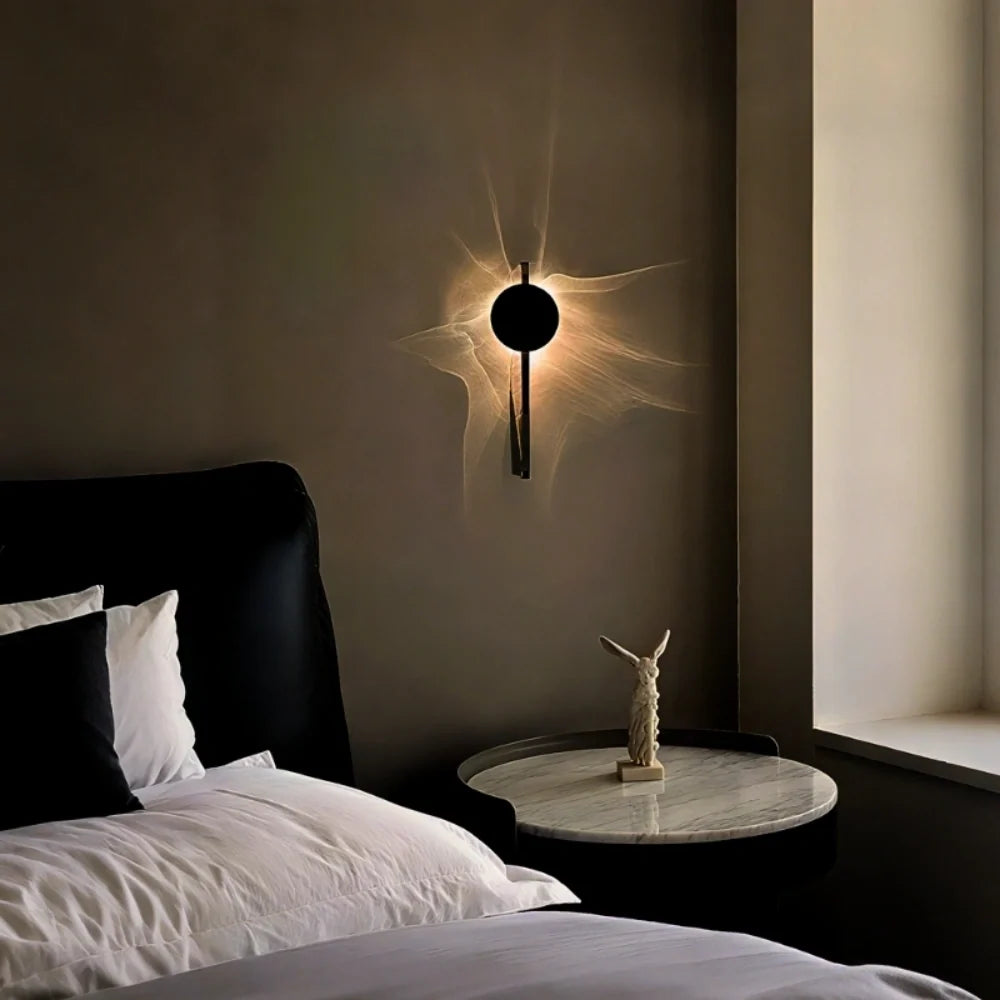 Solo wall sconce in bedroom setting above a round bedside table — soft ripple glow | Casa Norex
