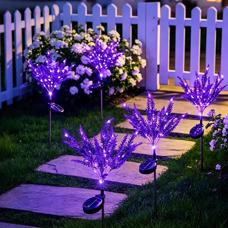 Purple lavender stake lights lining a garden path at night — Casa Norex