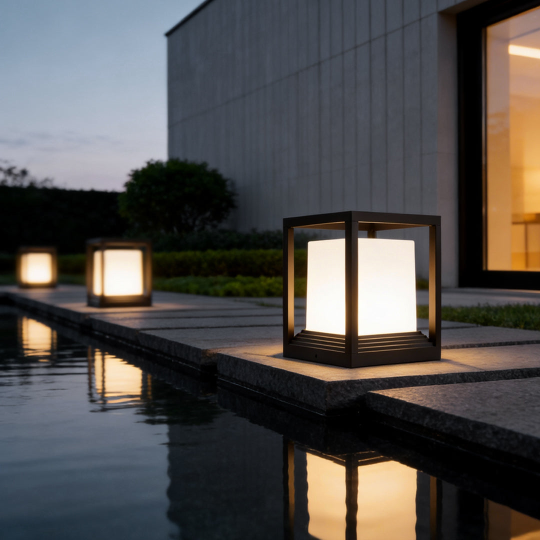 Plinth pedestal light by an infinity pool with warm glow — Casa Norex