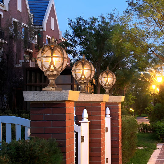 Aldous ornate bronze frame on brick pillars in a front yard — Casa Norex