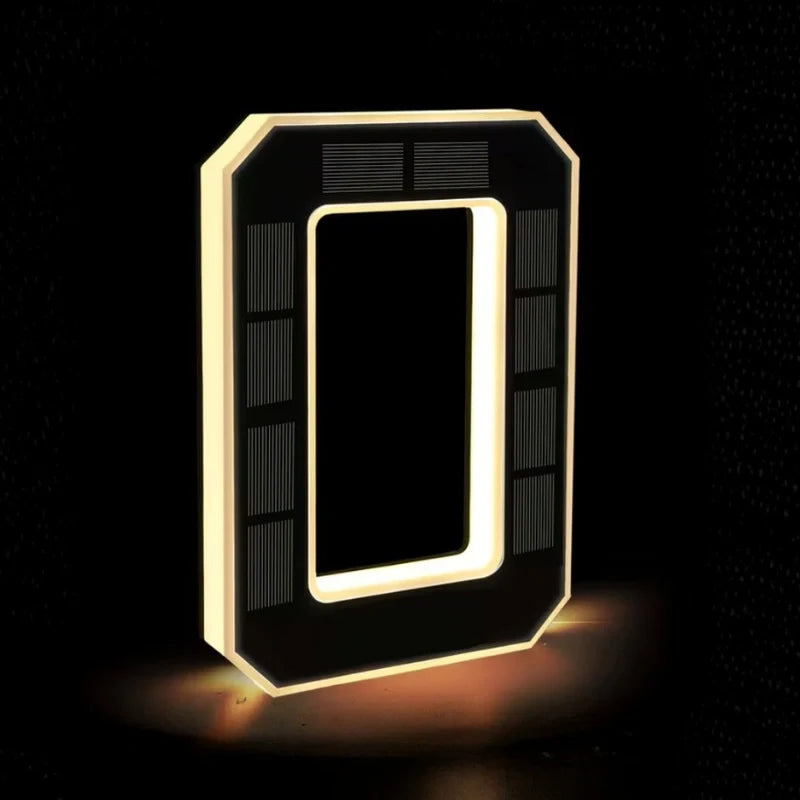 Illuminated number 0 in matte black with a warm glowing outline — Casa Norex