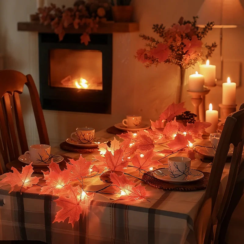 Autumn maple garland lights with red leaves on a dining table by a fireplace — Casa Norex