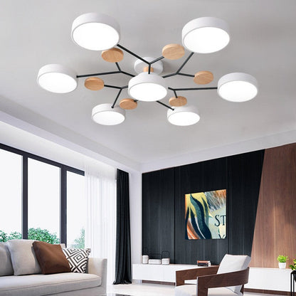 White 7-light branch ceiling light in a bright living room with large windows — Casa Norex