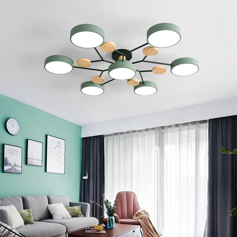 Green 7-light branch ceiling light in a living room with a green accent wall | Casa Norex