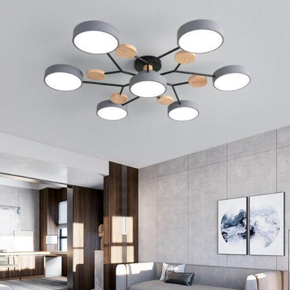Gray 7-light branch ceiling light in a living room with concrete wall and framed art — Casa Norex