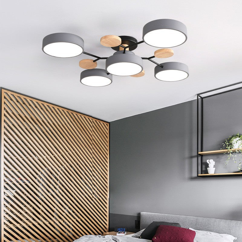 Gray branch ceiling light in a bedroom with a wood slat wall — Casa Norex