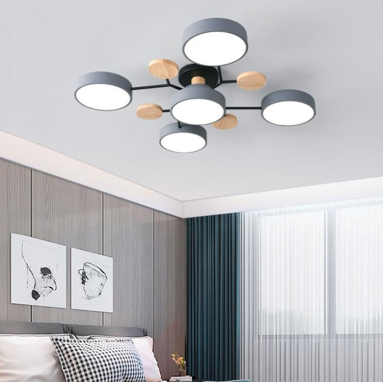 Gray 5-light branch ceiling light in a bedroom with paneled wall and curtains — Casa Norex