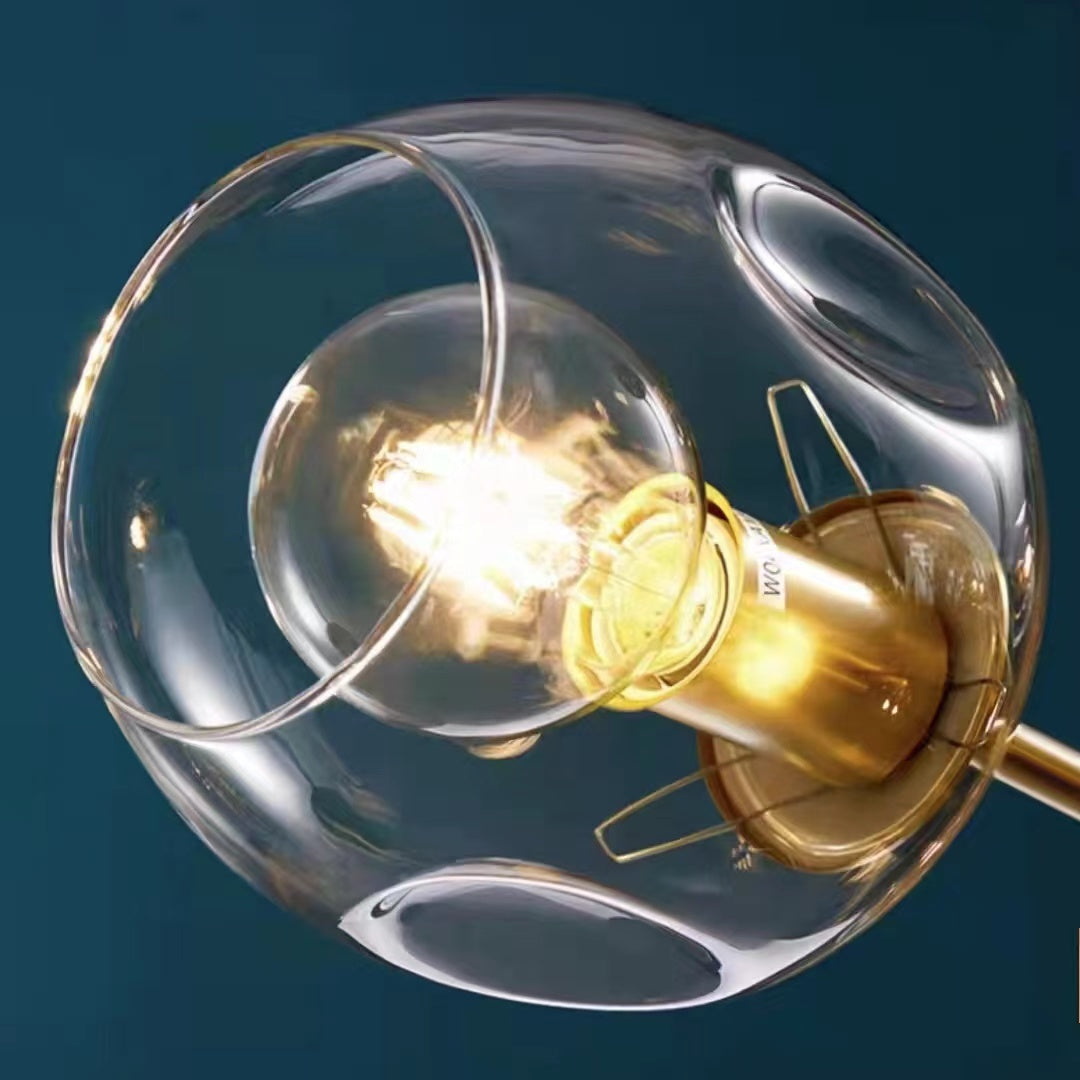 Clear globe arm chandelier lit ambient glow — Casa Norex
