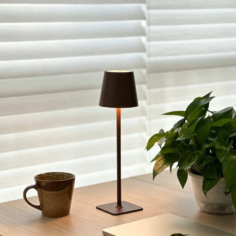 Matte brown table lamp on a table beside a mug and window blinds — Casa Norex