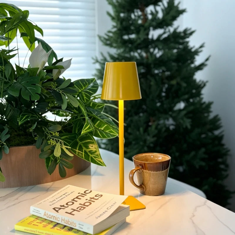 Matte yellow table lamp on a table with books and a mug — Casa Norex