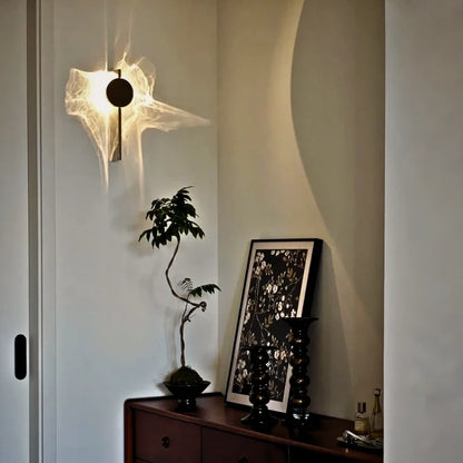Solo wall sconce beside a wooden console with bonsai and framed art in a hallway — Casa Norex