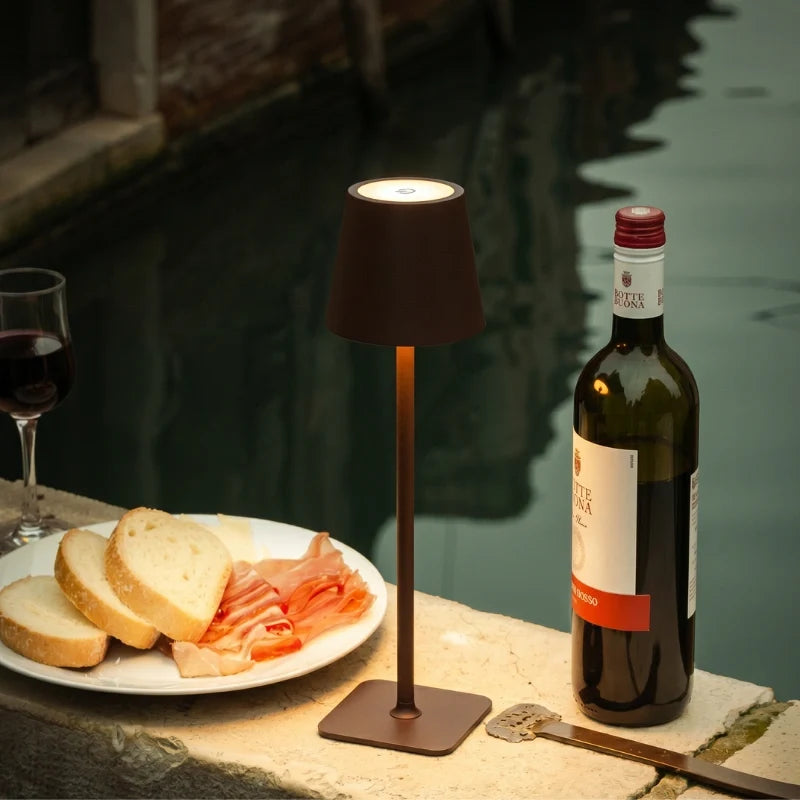 Brown table lamp on a dinner table beside bread and a wine bottle — Casa Norex