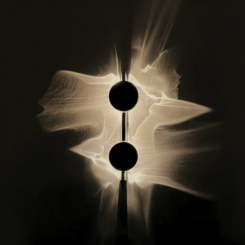 Duo wall sconce with two stacked discs spreading wave-like warm light across a dark wall | Casa Norex