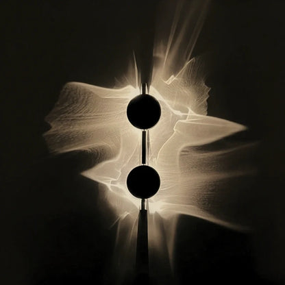 Duo wall sconce with two stacked discs spreading wave-like warm light across a dark wall | Casa Norex
