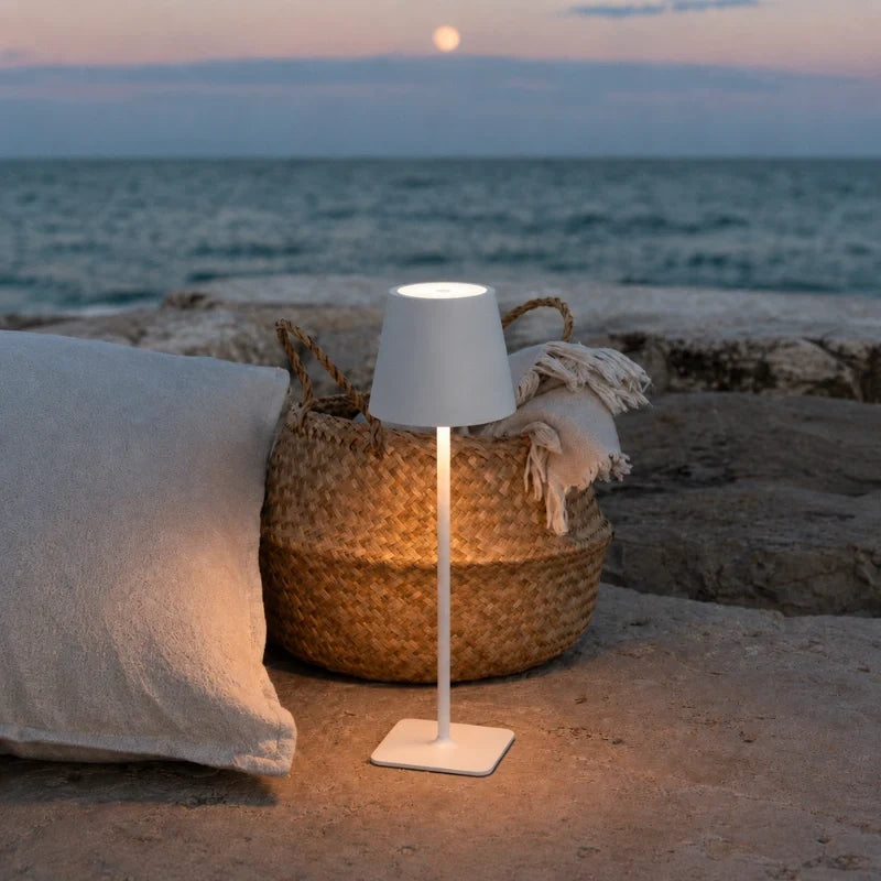 Table lamp in matte white on a seaside patio — cordless, USB-C rechargeable | Casa Norex