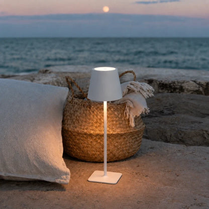 Table lamp in matte white on a seaside patio — cordless, USB-C rechargeable | Casa Norex