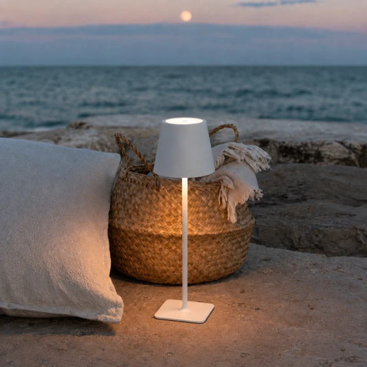 Table lamp in matte white on a seaside patio — cordless, USB-C rechargeable | Casa Norex