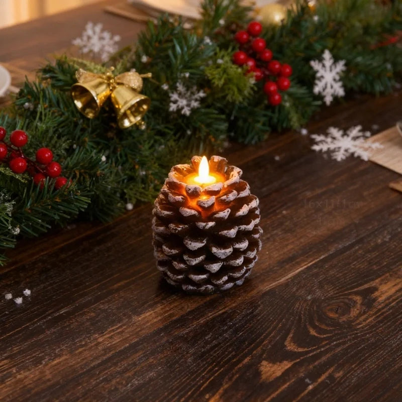 Pinecone flameless candle in dining table setting — white-tipped brown scales, lit LED flame | Casa Norex