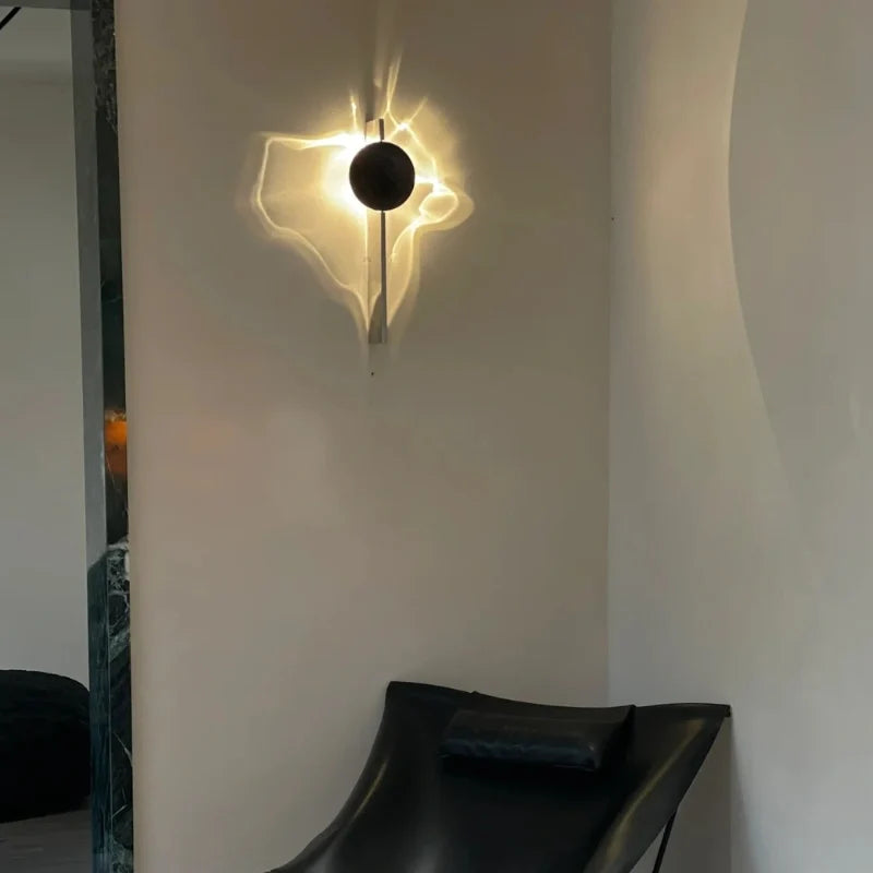 Solo wall sconce on a gray wall above a black leather chair in a corner — Casa Norex