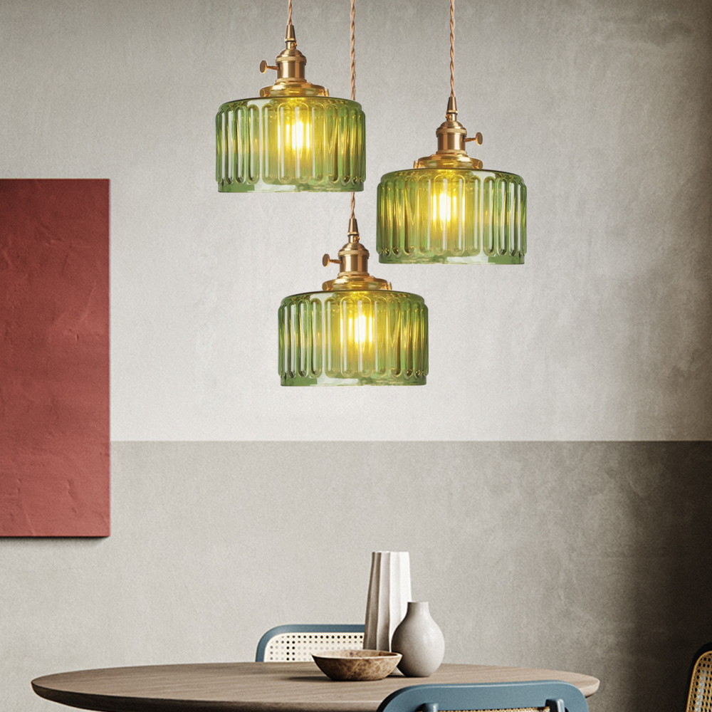 Close-up of green cylindrical glass shade on vintage pendant light | Casa Norex