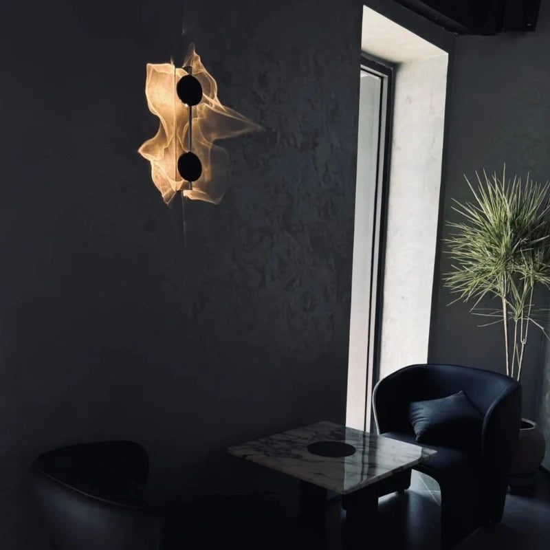Duo wall sconce in a dark living room beside an armchair and potted plant — Casa Norex