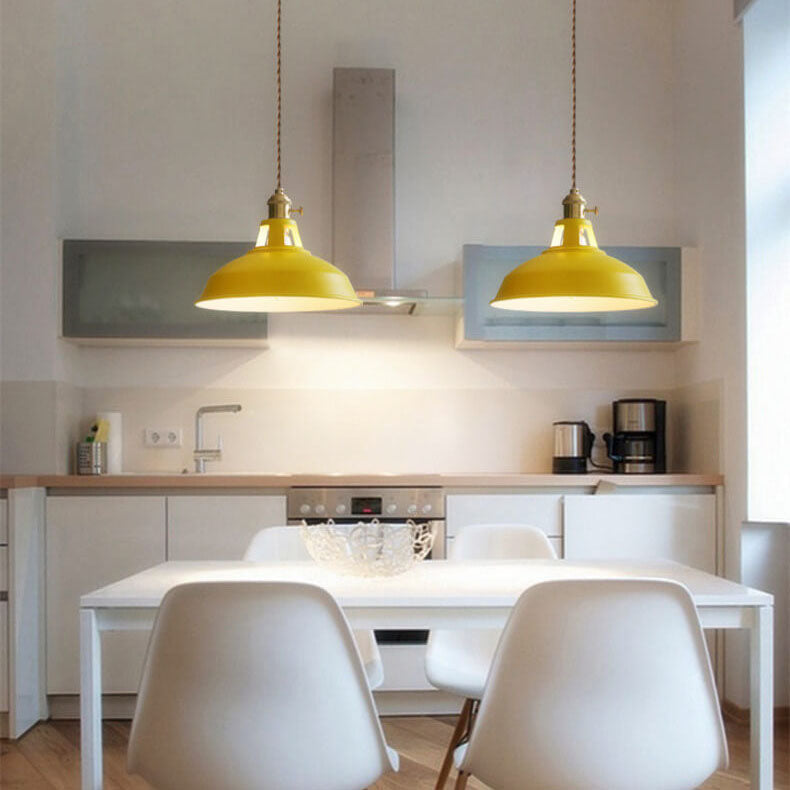 Two yellow barn shade pendant lights over a kitchen dining table — Casa Norex