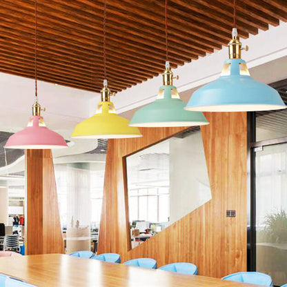 Pink, yellow, mint and blue barn shade pendants over a table under a wood slat ceiling — Casa Norex