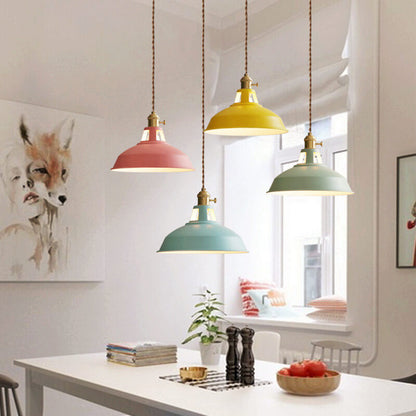 Colorful barn shade pendant light in pink, yellow and green over a dining table | Casa Norex
