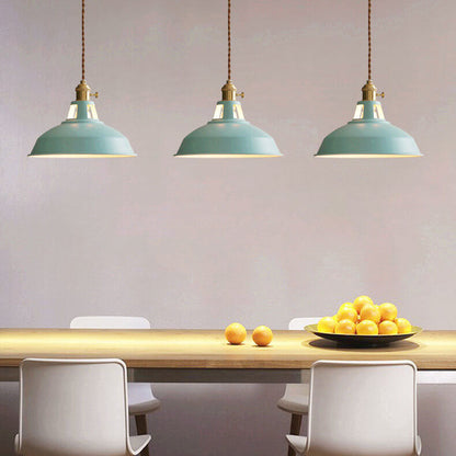 Three green barn shade pendant lights over a dining table with lemons — Casa Norex