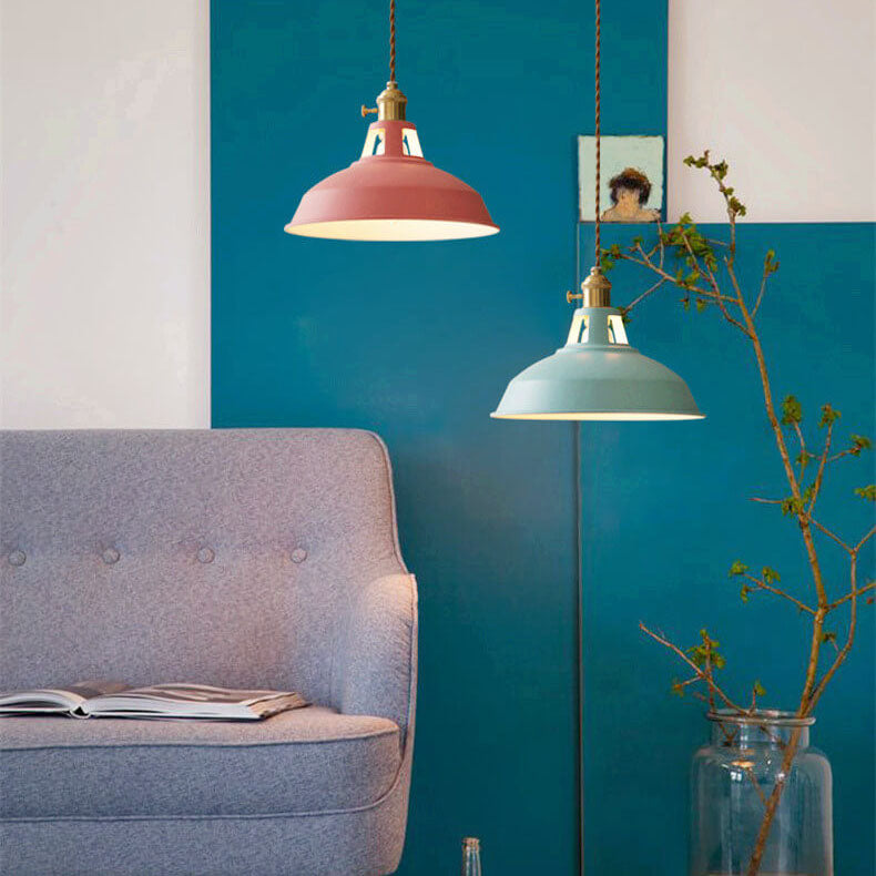 Pink and green barn shade pendant lights against a blue wall beside an armchair — Casa Norex
