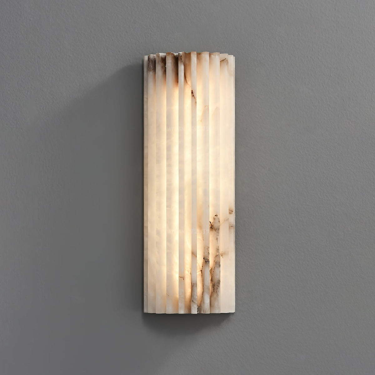 Wall sconce in bedroom setting — soft ambient stone glow | Casa Norex