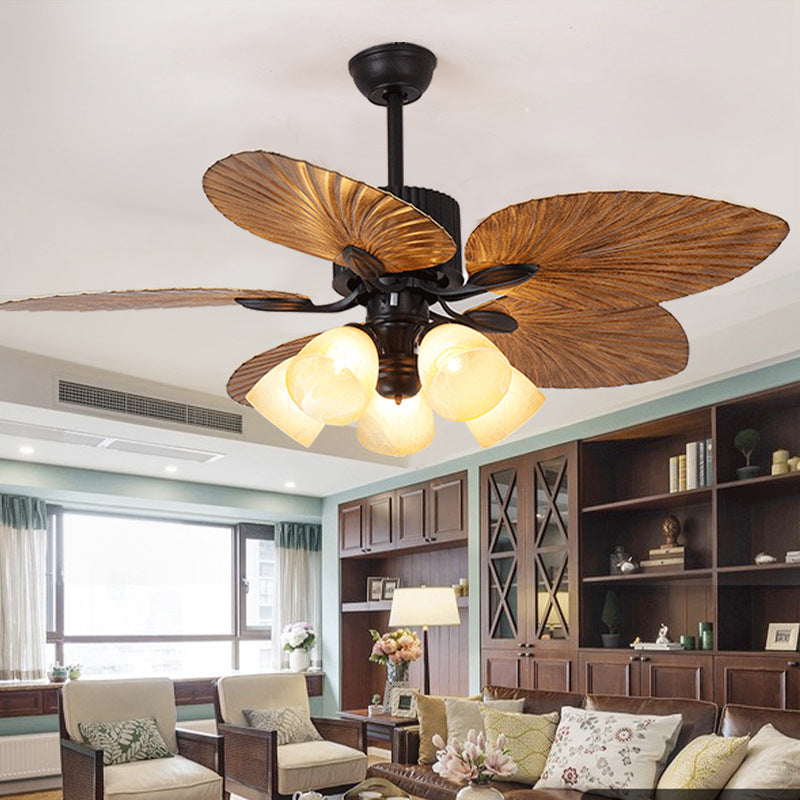 Copper palm-leaf ceiling fan light in living room setting — palm-leaf blades with bell shades | Casa Norex