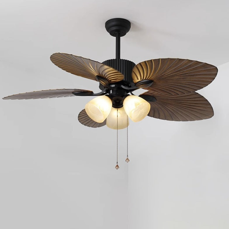 Close-up of glass bell shade and copper-finished arm on palm-leaf ceiling fan light | Casa Norex