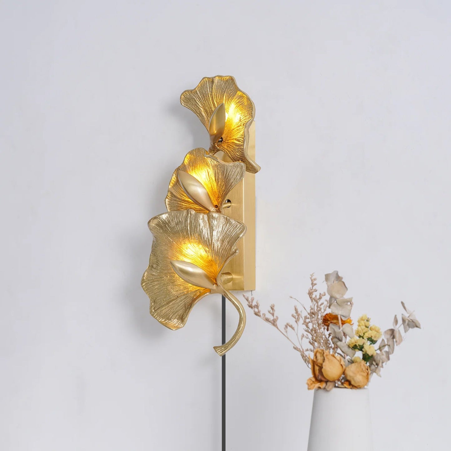 Ginkgo Leaf brass wall sconce warm glow interior - Casa Norex