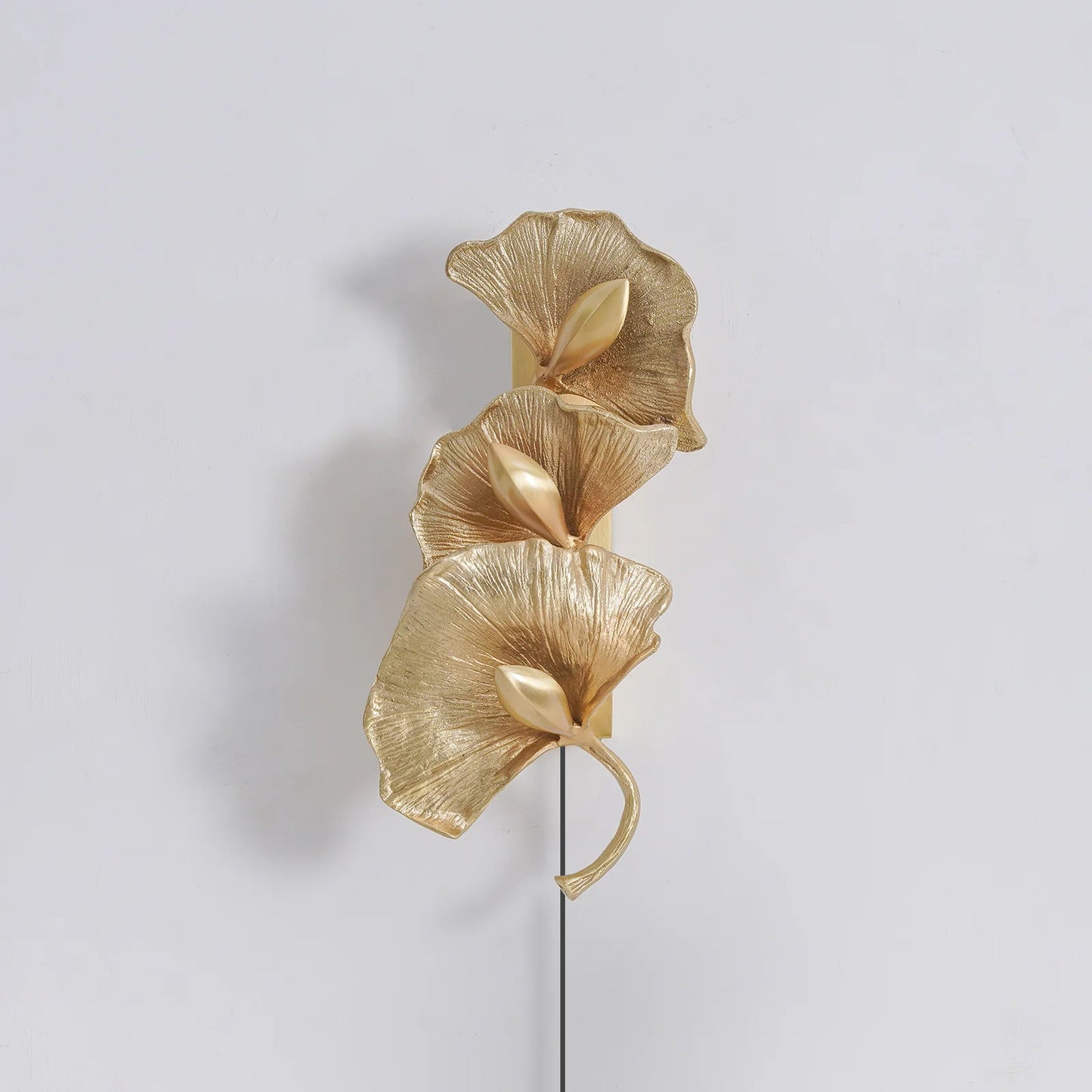 Polished brass ginkgo leaf shade close-up - plug-in wall sconce | Casa Norex