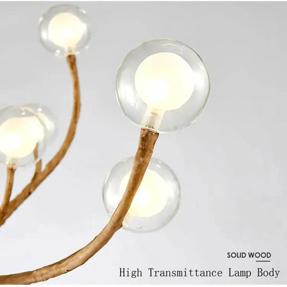 Tree chandelier lit over dining table — Casa Norex