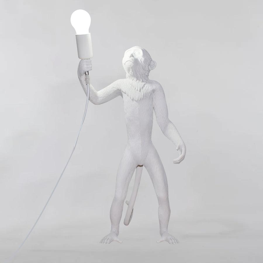 Close-up of monkey figures on resin table lamp | Casa Norex