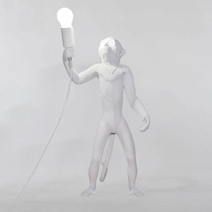Close-up of monkey figures on resin table lamp | Casa Norex