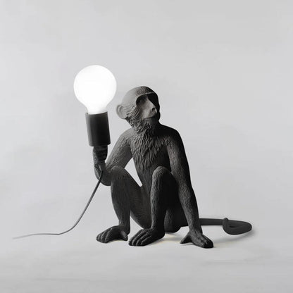 Monkey table lamp in modern living room setting — sculptural accent lighting | Casa Norex