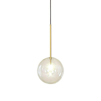 Close-up of glass globe shade on gold pendant | Casa Norex