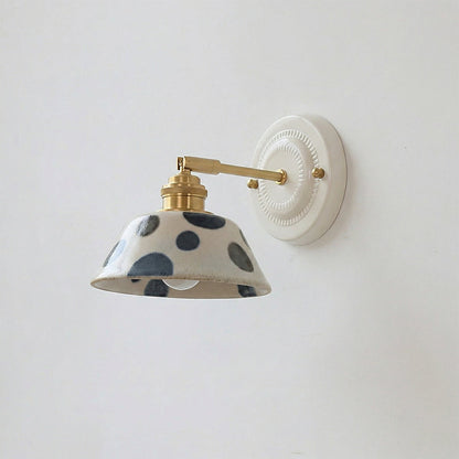 Close-up of hand-painted indigo motifs on ceramic wall sconce | Casa Norex