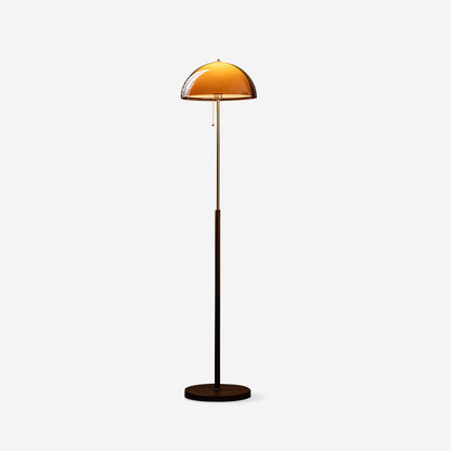 Rustina floor lamp beside reading chair - golden warmth - Casa Norex