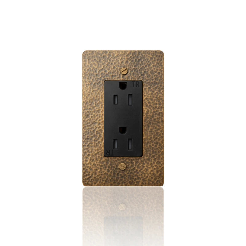 Close-up of single 15A hammered brass wall outlet | Casa Norex