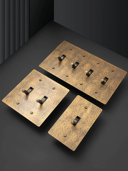 Hammered brass toggle switch installation detail — knurled lever close-up — Casa Norex